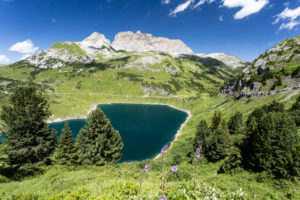 Formarinsee in front of red wall, clouds, blue heavens, summits Formarinsee in front of red wall, clouds, blue heavens, summits